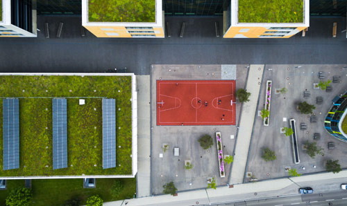 Aerial view of roof gardens and solar panels on the top of buildings.